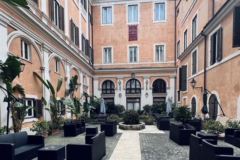 Courtyard at Hotel Antico Palazzo Rospigliosi in central Rome with outdoor seating and historic architecture